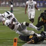 Michigan State running back LJ Scott (3) gets tackled by Arizona State safety Jalen Harvey (43) during the first half of an NCAA college football game Saturday, Sept. 8, 2018, in Tempe, Ariz. (AP Photo/Ross D. Franklin)