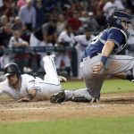 Arizona Diamondbacks' Jeff Mathis (2) dives safely into home plate on a double by Daniel Descalso as San Diego Padres catcher Austin Hedges (18) waits for the throw during the seventh inning of a baseball game, Tuesday, Sept. 4, 2018, in Phoenix. (AP Photo/Matt York)