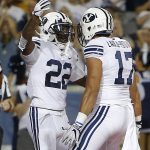 BYU running back Squally Canada (22) celebrates with Moroni Laulu-Pututau after scoring a first-half touchdown against Arizona during an NCAA college football game, Saturday, Sept. 1, 2018, in Tucson, Ariz. (AP Photo/Rick Scuteri)