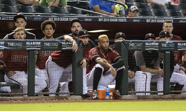 Arizona Diamondbacks players watch the last out of a basseball game against the Colorado Rockies wh...