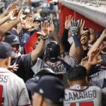 The Atlanta Braves dugout mobs Johan Camargo and Ronald Acuna in the ninth inning after Camargo hit a home run against the Arizona Diamondbacks during their baseball game Sunday, Sept. 9, 2018, in Phoenix. (AP Photo/Darryl Webb)