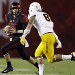 San Diego State quarterback Ryan Agnew, left, looks to pass as Arizona State linebacker Merlin Robertson defends during the first half of an NCAA college football game, Saturday, Sept. 15, 2018, in San Diego. (AP Photo/Gregory Bull)