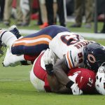 Chicago Bears linebacker Danny Trevathan, top, tackles Arizona Cardinals running back David Johnson (31) for a loss as Bears defensive end Roy Robertson-Harris, left, looks on during the first half of an NFL football game, Sunday, Sept. 23, 2018, in Glendale, Ariz. (AP Photo/Rick Scuteri)