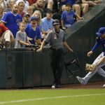 Chicago Cubs left fielder Kris Bryant, right, runs to get a double hit by Arizona Diamondbacks' Eduardo Escobar as security moves out of the way during the fourth inning of a baseball game Monday, Sept. 17, 2018, in Phoenix. (AP Photo/Ross D. Franklin)