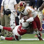 Washington Redskins cornerback Quinton Dunbar (23) is hit by Arizona Cardinals tight end Ricky Seals-Jones (86) after incepting a pass during the second half of an NFL football game, Sunday, Sept. 9, 2018, in Glendale, Ariz. (AP Photo/Rick Scuteri)