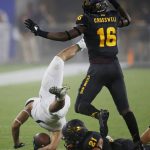 Michigan State wide receiver Cody White, left, gets upended by Arizona State cornerback Terin Adams (21) as Arizona State safety Aashari Crosswell (16) jumps over his teammate during the first half of an NCAA college football game Saturday, Sept. 8, 2018, in Tempe, Ariz. (AP Photo/Ross D. Franklin)