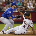 Arizona Diamondbacks' Eduardo Escobar (14) slides safely into third base after tagging up on a fly ball out as Chicago Cubs third baseman David Bote, left, waits for a late throw during the fourth inning of a baseball game Monday, Sept. 17, 2018, in Phoenix. (AP Photo/Ross D. Franklin)