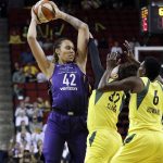 Phoenix Mercury's Brittney Griner (42) is double-teamed by Seattle Storm's Alysha Clark (32) and Natasha Howard (6) during the first half of Game 5 of a WNBA basketball playoffs semifinal, Tuesday, Sept. 4, 2018, in Seattle. (AP Photo/Elaine Thompson)