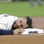 Houston Astros' George Springer rests his head on third base after advancing from first on a single by Jose Altuve during the first inning of baseball game against the Arizona Diamondbacks Sunday, Sept. 16, 2018, in Houston. (AP Photo/David J. Phillip)