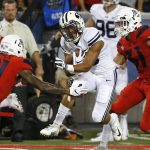 BYU wide receiver Aleva Hifo breaks the tackle by Arizona safety Isaiah Hayes (21) during the first half of an NCAA college football game Saturday, Sept. 1, 2018, in Tucson, Ariz. (AP Photo/Rick Scuteri)