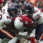 Chicago Bears linebacker Khalil Mack (52) makes a tackle on Arizona Cardinals running back David Johnson (31) with help from Danny Trevathan (59) during the first half of an NFL football game, Sunday, Sept. 23, 2018, in Glendale, Ariz. (AP Photo/Ralph Freso)
