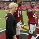 Cindy McCain, wife of the late U.S. Sen. John McCain, R-Ariz., stands with Arizona Cardinals wide receiver Larry Fitzgerald (11) as an honorary team captain during the coin toss prior to an NFL football game against the Washington Redskins, Sunday, Sept. 9, 2018, in Glendale, Ariz. (AP Photo/Ross D. Franklin, Pool)