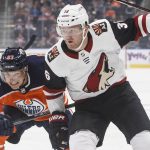 Arizona Coyotes ' Christian Fischer (36) and Edmonton Oilers' Matthew Benning (83) vie for the puck during the first period of an NHL hockey preseason game Thursday, Sept. 27, 2018, in Edmonton, Alberta. (Jason Franson/The Canadian Press via AP)