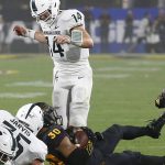 Michigan State quarterback Brian Lewerke (14) looks down at Arizona State defensive back Dasmond Tautalatasi (30) after Lewerke's interception during the first half of an NCAA college football game Saturday, Sept. 8, 2018, in Tempe, Ariz. (AP Photo/Ross D. Franklin)