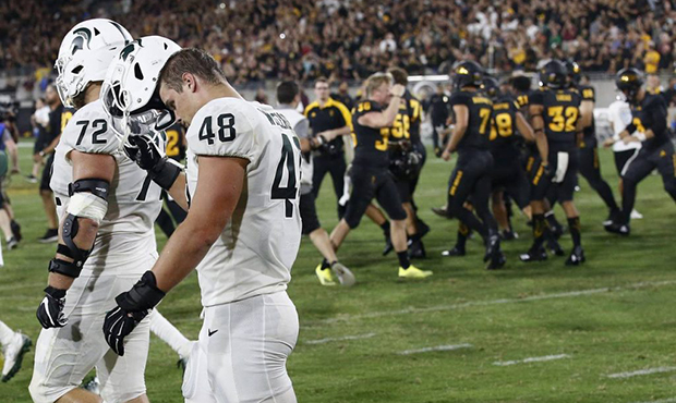 As Arizona State players celebrate a game-winning field goal, Michigan State defensive end Kenny Wi...