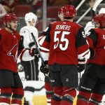 Arizona Coyotes center Vinnie Hinostroza (13) celebrates his goal against the Los Angeles Kings with Jason Demers (55) and Clayton Keller, right, during the first period of an NHL preseason hockey game Tuesday, Sept. 18, 2018, in Glendale, Ariz. (AP Photo/Ross D. Franklin)