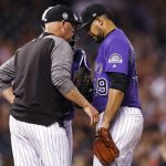 Colorado Rockies pitching coach Steve Foster, left, confers with starting pitcher Antonio Senzatela after he gave up a triple to drive in two runs to Arizona Diamondbacks' Ketel Marte in the sixth inning of a baseball game, Tuesday, Sept. 11, 2018, in Denver. (AP Photo/David Zalubowski)