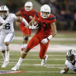 Arizona wide receiver Shawn Poindexter (19) gains a first down against BYU during the first half of an NCAA college football game Saturday, Sept. 1, 2018, in Tucson, Ariz. (AP Photo/Rick Scuteri)
