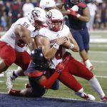Southern Utah quarterback Chris Helbig (8) scores a touchdown over the top of Arizona defensive end Lee Anderson III in the second half during an NCAA college football game, Saturday, Sept. 15, 2018, in Tucson, Ariz. (AP Photo/Rick Scuteri)