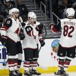 Arizona Coyotes forward Conor Garland (83) celebrates his goal with teammates during the second period of a preseason NHL hockey game against Los Angeles Kings on Tuesday, Sept. 18, 2018, in Los Angeles. (AP Photo/Ringo H.W. Chiu)
