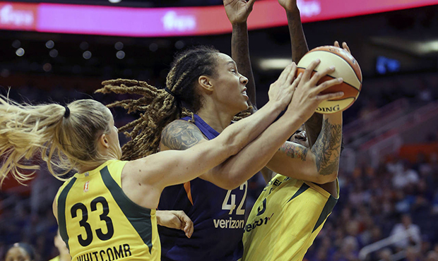 Phoenix Mercury center Brittney Griner (42) is guarded by Seattle Storm's Sami Whitcomb (33) and Na...