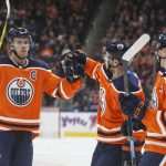 Edmonton Oilers' Connor McDavid (97), Ty Rattie (8) and Ryan Nugent-Hopkins (93) celebrate a goal against the Arizona Coyotes during the second period of an NHL hockey preseason game Thursday, Sept. 27, 2018, in Edmonton, Alberta. (Jason Franson/The Canadian Press via AP)