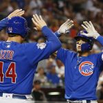 Chicago Cubs' Javier Baez, right, celebrates his two-run home run against the Arizona Diamondbacks with Anthony Rizzo (44) during the sixth inning of a baseball game Monday, Sept. 17, 2018, in Phoenix. (AP Photo/Ross D. Franklin)