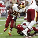 Washington Redskins running back Adrian Peterson (26) is grabbed by Arizona Cardinals defensive back Antoine Bethea (41) during the first half of an NFL football game, Sunday, Sept. 9, 2018, in Glendale, Ariz. (AP Photo/Rick Scuteri)