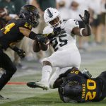 Michigan State wide receiver Darrell Stewart Jr. (25) gets tackled by Arizona State defensive back Chase Lucas (24) and linebacker Khaylan Kearse-Thomas (20) during the second half of an NCAA college football game Saturday, Sept. 8, 2018, in Tempe, Ariz. Arizona State defeated Michigan State 16-13. (AP Photo/Ross D. Franklin)