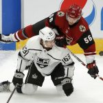 Arizona Coyotes left wing Kevin Klima (56) flips over Los Angeles Kings forward Brad Morrison (63) during the third period of an NHL preseason hockey game Tuesday, Sept. 18, 2018, in Glendale, Ariz. The Coyotes defeated the Kings 4-2. (AP Photo/Ross D. Franklin)