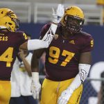 Arizona State defensive lineman Shannon Forman (97) celebrates with teammate Chase Lucas after returning an interception for a touchdown against UTSA during the first half of an NCAA college football game, Saturday, Sept. 1, 2018, in Tempe, Ariz. (AP Photo/Ralph Freso)