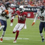 Chicago Bears defensive back Eddie Jackson, left, intercepts pass intended for Arizona Cardinals wide receiver J.J. Nelson (14) as Bears defensive back Prince Amukamara (20) looks on during the second half of an NFL football game, Sunday, Sept. 23, 2018, in Glendale, Ariz. (AP Photo/Rick Scuteri)