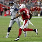 Seattle Seahawks quarterback Russell Wilson (3) throws as Arizona Cardinals defensive back Antoine Bethea (41) pursues during the second half of an NFL football game, Sunday, Sept. 30, 2018, in Glendale, Ariz. (AP Photo/Rick Scuteri)