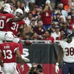 Arizona Cardinals running back David Johnson (31) celebrates his touchdown catch with Chad Williams (10), and Christian Kirk (13) as Chicago Bears defensive back Adrian Amos (38) looks on during the first half of an NFL football game, Sunday, Sept. 23, 2018, in Glendale, Ariz. (AP Photo/Ralph Freso)