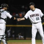 Arizona Diamondbacks relief pitcher Yoshihisa Hirano greets catcher Jeff Mathis after the team's 6-0 win over the San Diego Padres in a baseball game Tuesday, Sept. 4, 2018, in Phoenix. (AP Photo/Matt York)