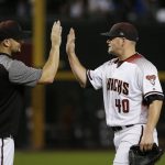 Arizona Diamondbacks relief pitcher Andrew Chafin (40) celebrates with Zack Godley after the final out of a baseball game against the Chicago Cubs on Wednesday, Sept. 19, 2018, in Phoenix. The Diamondbacks defeated the Cubs 9-0. (AP Photo/Ross D. Franklin)