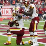 Washington Redskins running back Adrian Peterson (26) celebrates his touchdown against the Arizona Cardinals with tight end Vernon Davis (85) during the first half of an NFL football game, Sunday, Sept. 9, 2018, in Glendale, Ariz. (AP Photo/Rick Scuteri)
