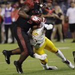 San Diego State running back Juwan Washington, left, gets past Arizona State safety Aashari Crosswell as he scores a touchdown during the first half of an NCAA college football game Saturday, Sept. 15, 2018, in San Diego. (AP Photo/Gregory Bull)