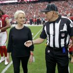 Cindy McCain, wife of the late U.S. Sen. John McCain, R-Ariz., talks with referee Walt Coleman as she walks out with Arizona Cardinals and Washington Redskins players as an honorary team captain for the coin toss prior to an NFL football game , Sunday, Sept. 9, 2018, in Glendale, Ariz. (AP Photo/Ross D. Franklin, Pool)