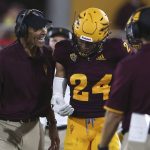 Arizona State head coach Herm Edwards, left, talks to defensive back Chase Lucas (24) during the first half of an NCAA college football game against UTSA, Saturday, Sept. 1, 2018, in Tempe, Ariz. (AP Photo/Ralph Freso)