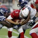 Arizona Cardinals quarterback Josh Rosen (3) is sacked by Seattle Seahawks linebacker Barkevious Mingo (51) and defensive tackle Jarran Reed (90) during the first half of an NFL football game, Sunday, Sept. 30, 2018, in Glendale, Ariz. (AP Photo/Ross D. Franklin)