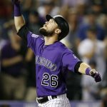 Colorado Rockies' David Dahl gestures as he crosses home plate after hitting a grand slam off Arizona Diamondbacks relief pitcher Matt Andriese in the seventh inning of a baseball game Monday, Sept. 10, 2018, in Denver. (AP Photo/David Zalubowski)