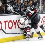 Los Angeles Kings defenseman Chaz Reddekopp (82) collides with Arizona Coyotes forward Nick Cousins (25) during the second period of a preseason NHL hockey game Tuesday, Sept. 18, 2018, in Los Angeles. (AP Photo/Ringo H.W. Chiu)