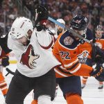 Arizona Coyotes ' Jason Demers (55) gets his stick up on Edmonton Oilers' Tobias Rieder (22) during the second period of an NHL hockey preseason game Thursday, Sept. 27, 2018, in Edmonton, Alberta. (Jason Franson/The Canadian Press via AP)
