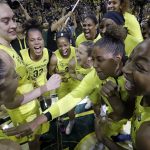 Seattle Storm players gather in a celebratory huddle after a 94-84 win over the Phoenix Mercury during Game 5 of a WNBA basketball playoff semifinal, Tuesday, Sept. 4, 2018, in Seattle. The Storm advanced to the WNBA finals. (AP Photo/Elaine Thompson)