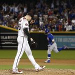 Arizona Diamondbacks starting pitcher Patrick Corbin (46) pauses on the mound after giving up a two-run home run to Chicago Cubs' Javier Baez, right, during the sixth inning of a baseball game Monday, Sept. 17, 2018, in Phoenix. (AP Photo/Ross D. Franklin)
