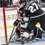 Los Angeles Kings goalie Jonathan Quick (32) protects the net as defenseman Alec Martinez (27) and Arizona Coyotes forward Michael Bunting (58) compete for the puck during the second period of a preseason NHL hockey game Tuesday, Sept. 18, 2018, in Los Angeles. (AP Photo/Ringo H.W. Chiu)