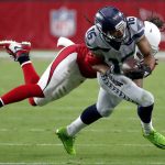 Seattle Seahawks wide receiver Tyler Lockett (16) is hit by Arizona Cardinals defensive back Bene' Benwikere during the first half of an NFL football game, Sunday, Sept. 30, 2018, in Glendale, Ariz. (AP Photo/Rick Scuteri)