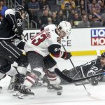 Los Angeles Kings defenseman Alec Martinez (27) falls as Arizona Coyotes forward Conor Garland (83) controls the puck during the second period of a preseason NHL hockey game Tuesday, Sept. 18, 2018, in Los Angeles. (AP Photo/Ringo H.W. Chiu)