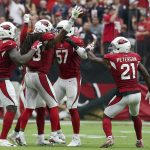 Arizona Cardinals defensive back Tre Boston, second from right, celebrates his interception against the Chicago Bears with Benson Mayowa, left, Josh Bynes (57) and Patrick Peterson (21) during the first half of an NFL football game, Sunday, Sept. 23, 2018, in Glendale, Ariz. (AP Photo/Ralph Freso)